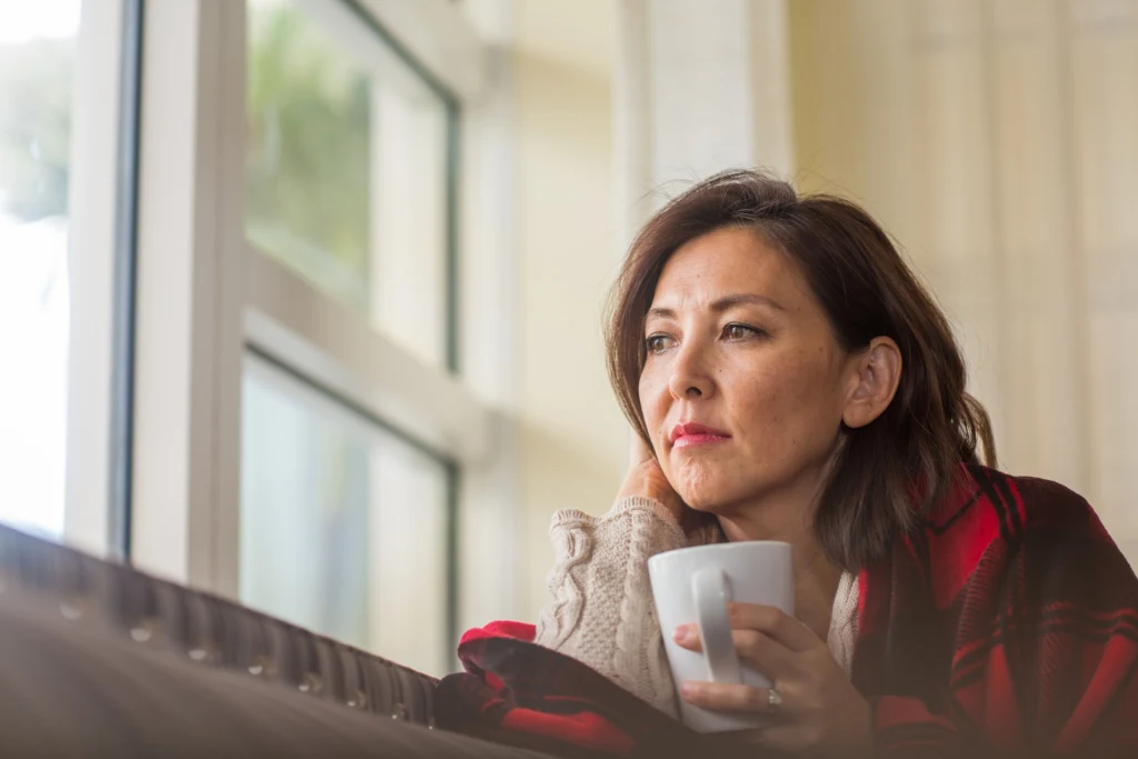 mature-woman-looking-out-the-window-feeling-sad-combat-seasonal-depression